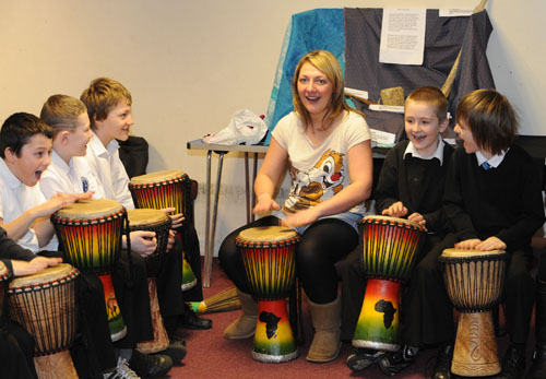 P6 practising the African drums at Methilhill Primary and Community School, Fife
