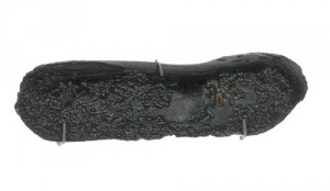 Indochinite (tektite), dull black elongated dumb-bell with surface pitting, from Villa Alliance, Da Lat, Lam Dong Province, Vietnam