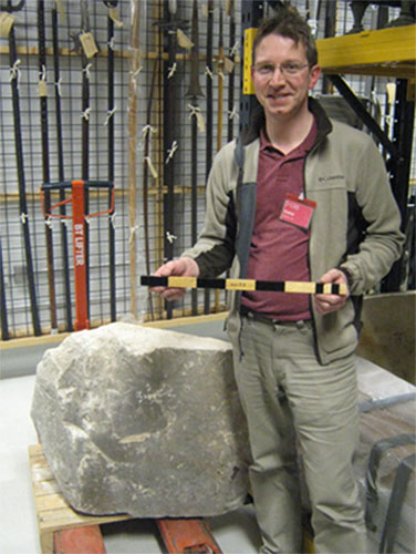 David Lightbody with the pyramid casing stone (A.1955.176) and his replica Egyptian cubit measuring rod