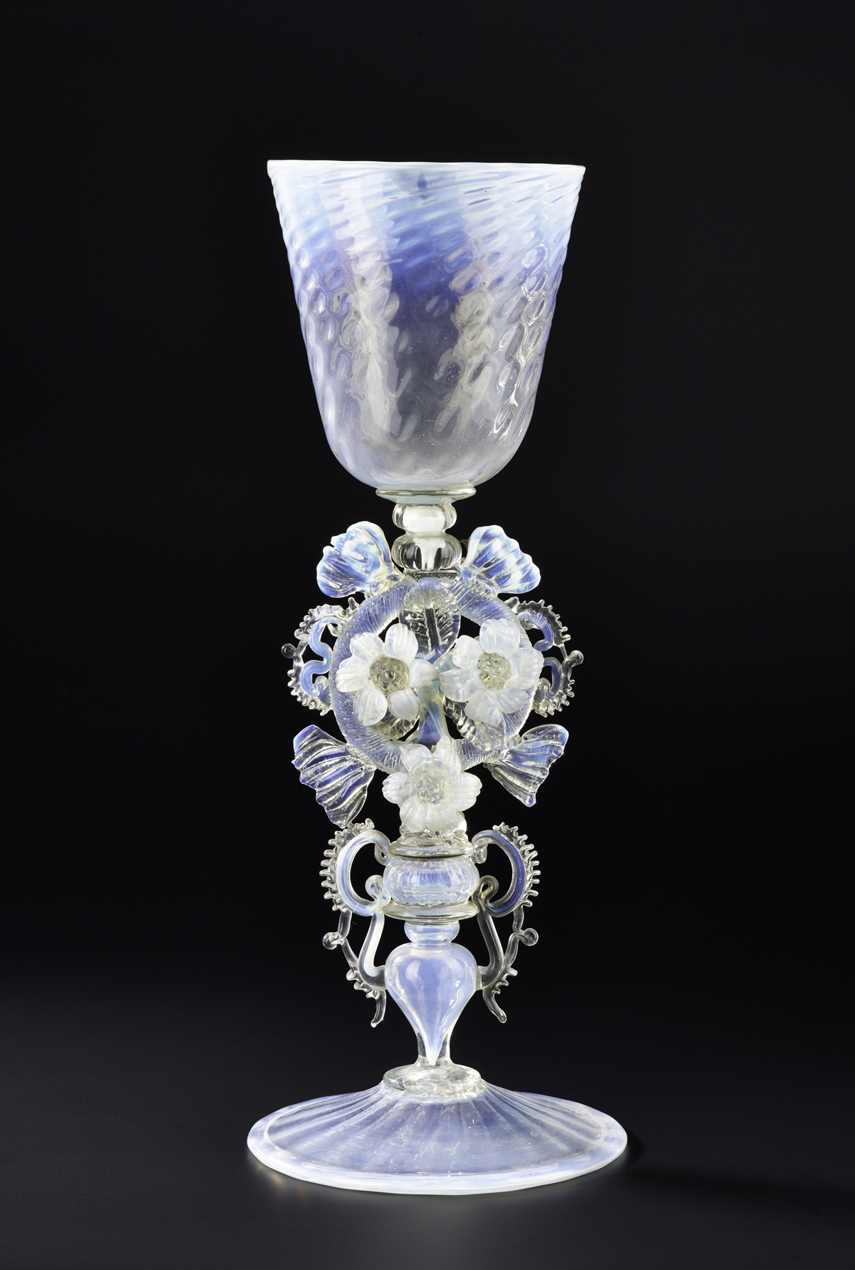 A.1873.27.2 - Tall goblet of opal glass with winged stem, flowers in relief and spirally ribbed bowl: Italian, Venetian, 19th century.
