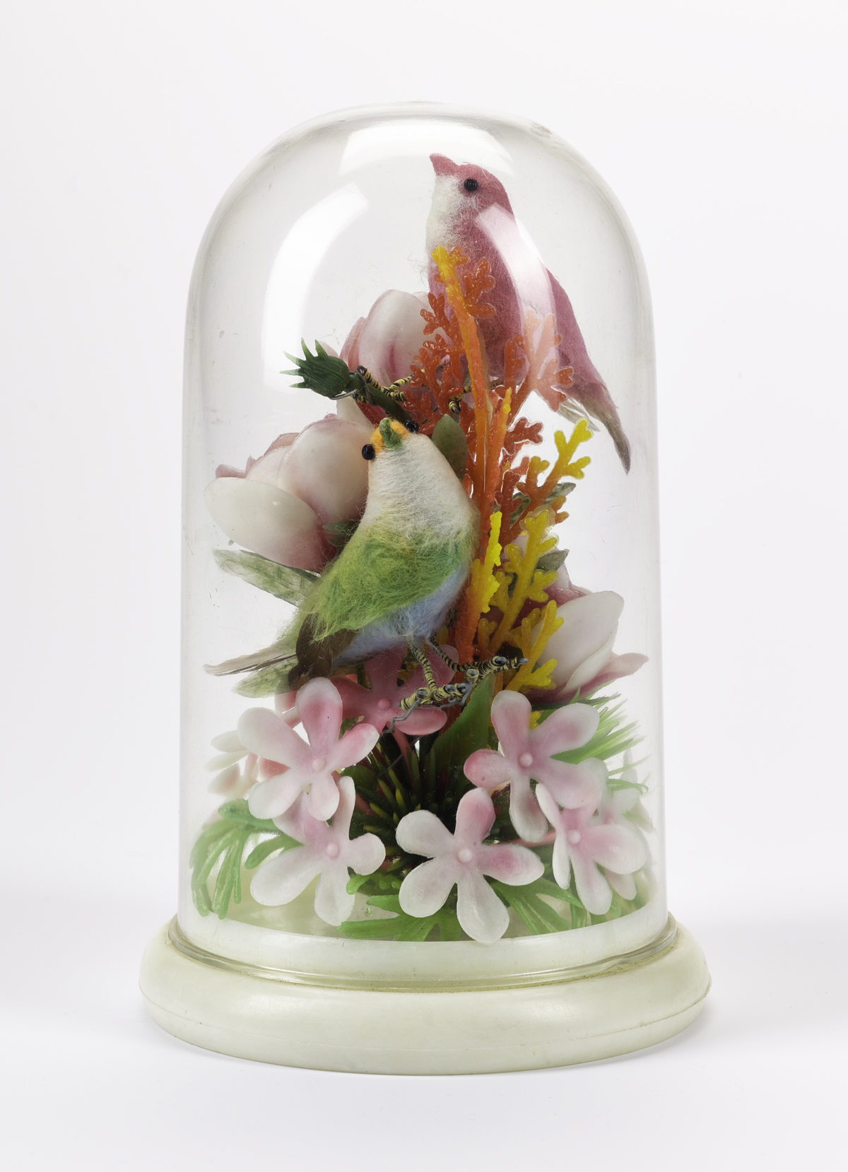 A.1990.1313 - Ornament in form of a plastic dome containing a display of pink plastic flowers and two birds,  one pink and one green, made in Hong Kong.