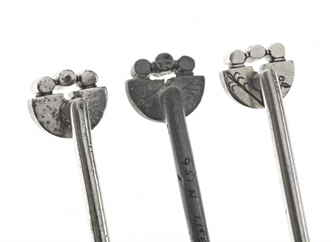 The backs of three handpins – the original Pictish pin on the left, and the 1839 pewter copy in the middle and the silver copy on the right with their ‘z-rods’
