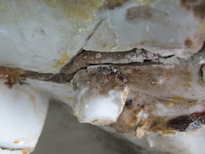 You can see the white plaster-like material covering a small insert of wood in the middle of this photograph, with brown resin at the bottom.