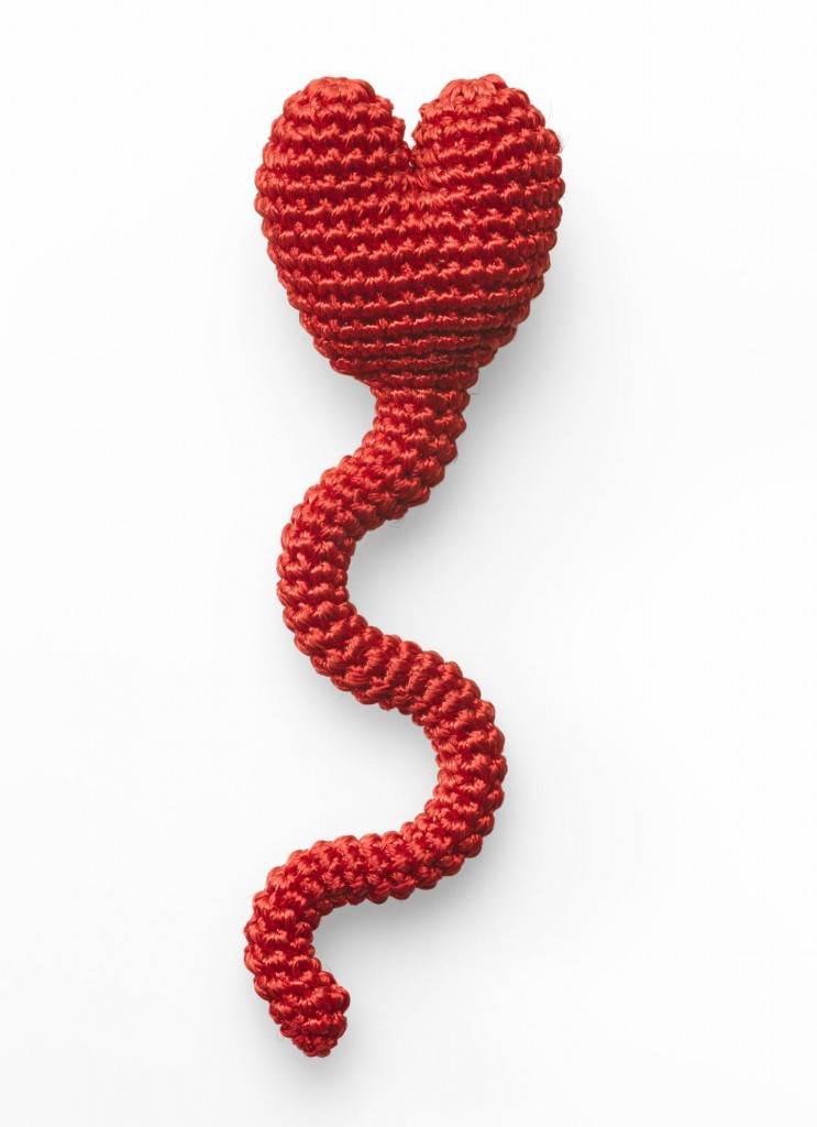 Spermheart brooch of textile and rubber with broad, heart-shaped upper part, sinuous narrow lower section and metal base, by Felieke van der Leest, 1999.