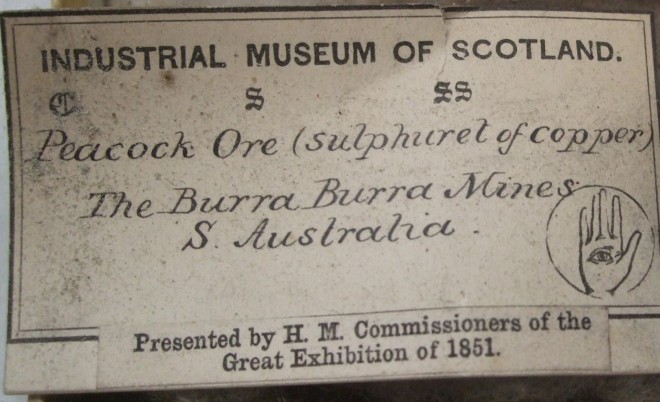 Label from a sample of Peacock Ore, presented by H.M. Commissioners of the Great Exhibition of 1851, with George Wilson’s Industrial Museum crest.