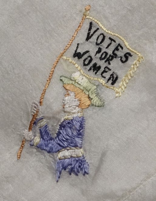 Suffragette hankerchief in green, white and purple, the colours most associated with the Women's Social and Political Union., one of the main Suffragette organisations under the leadership of Emmeline Pankhurst. On display in Scotland a Changing National at National Museum of Scotland.