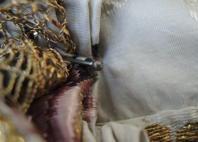 Metal pin discovered in the waist of the mantua’s bodice during surface cleaning.