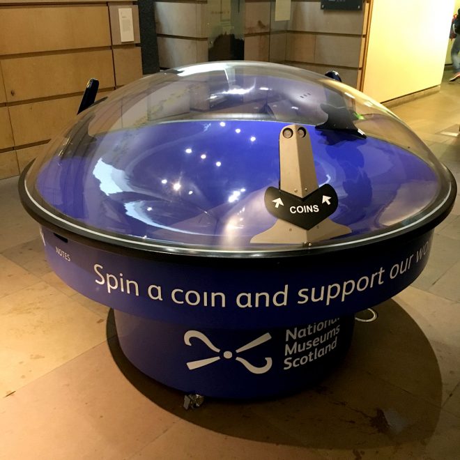 Coin spinning donation box