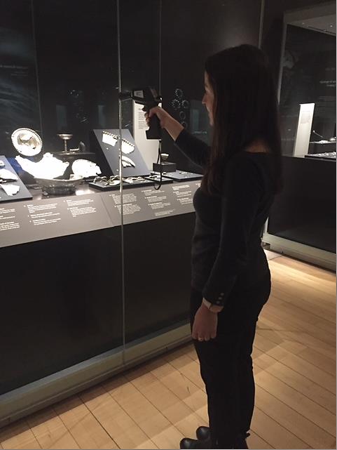 Tatiana Marasco conducting “air leak” test of the display cases to make sure all is in order.