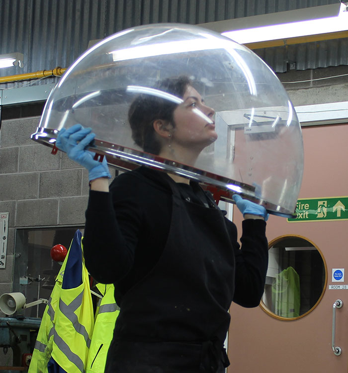 Julia Tauber, Assistant Conservator, examining the Perspex dome during the polishing process
