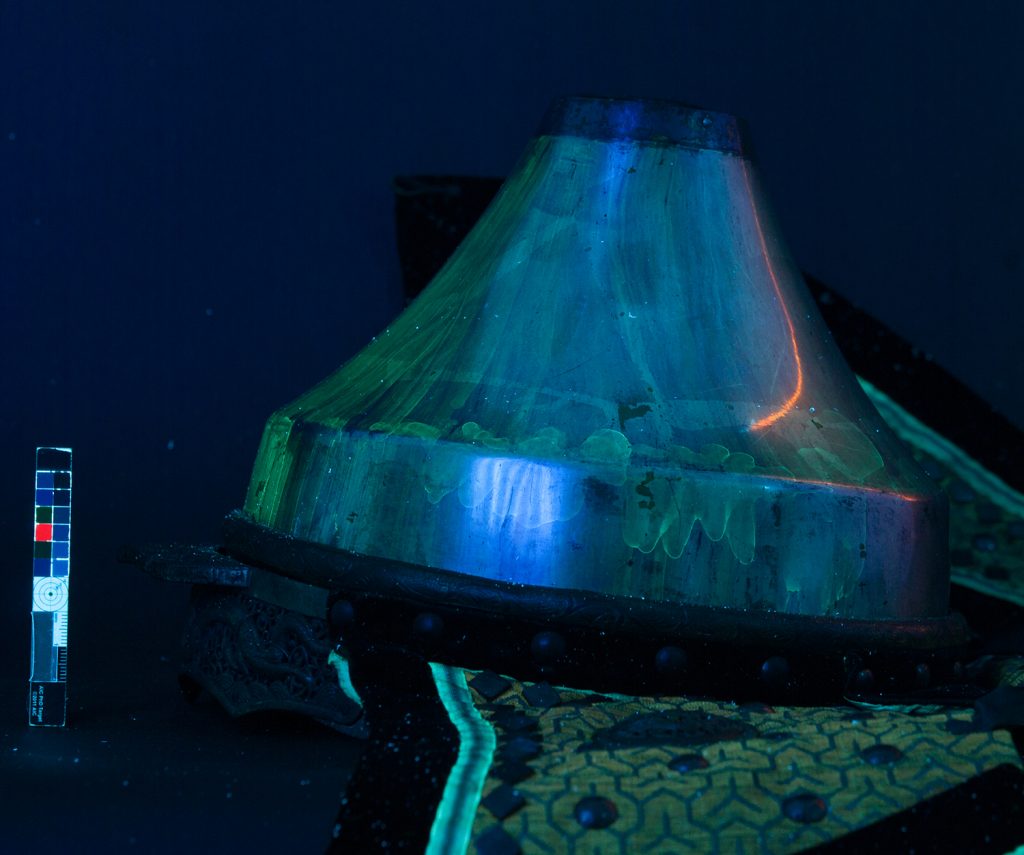 The helmet under UV light showing the lacquer.
