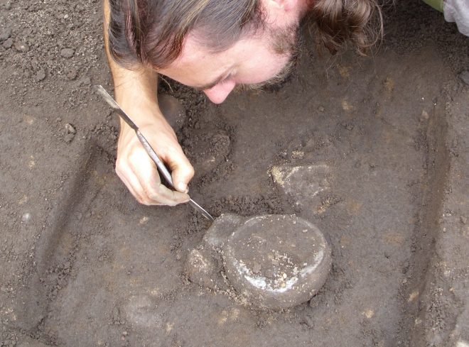 Iron Age stone lamp under excavation at Clarkly Hill, Moray