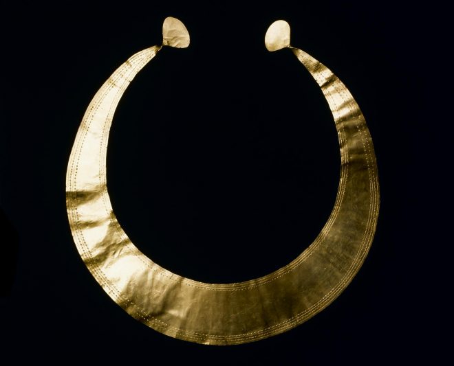 Gold lunula tapering to extremities where it ends in sub-oval disc-like expansions, ornamented with incised lines and punctulations, from Southside, near Coulter, Lanarkshire, 2300 - 2000 BC