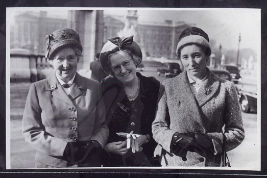 A black and white image of three women wearing hats, taken in 1961