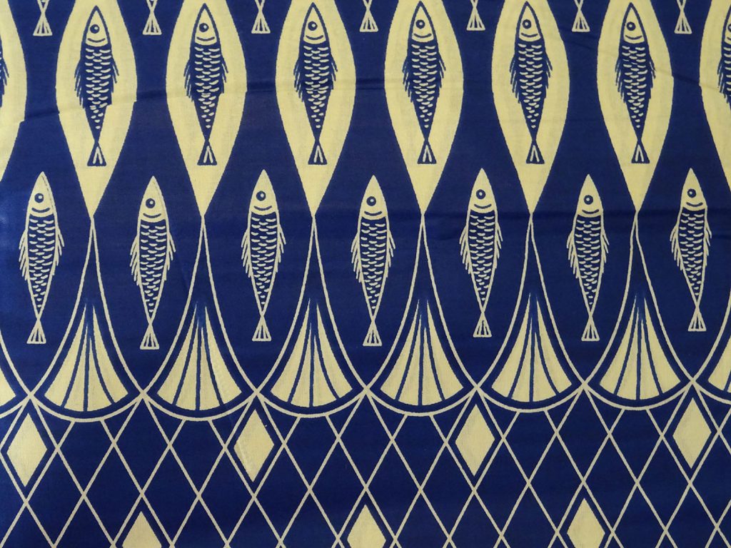 Blue and cream capulana cloth decorated with a fish pattern