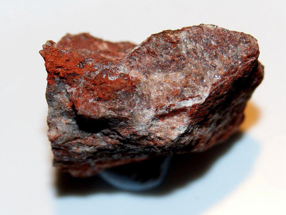 Bright red macaulayite on granite from Bennachie