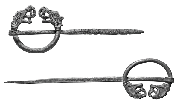 Grey images of two brooches, one above the other, each with dragon-like ends and very long pins cutting across horizontally. 