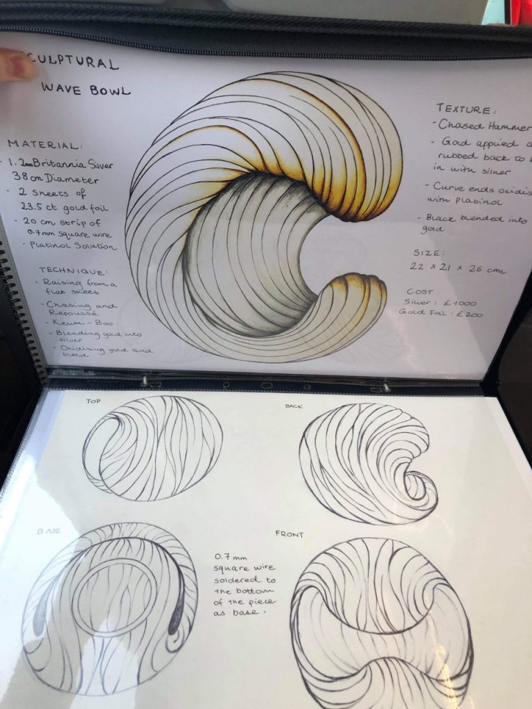 Sketches in a portfolio showing five different views of the design. 

There are notes detailing Material, Technique, Texture, Size and Cost. 
