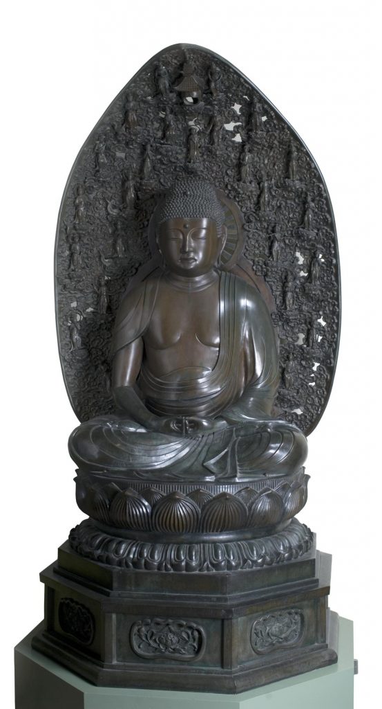A large Buddha statue photographed against a white background.
