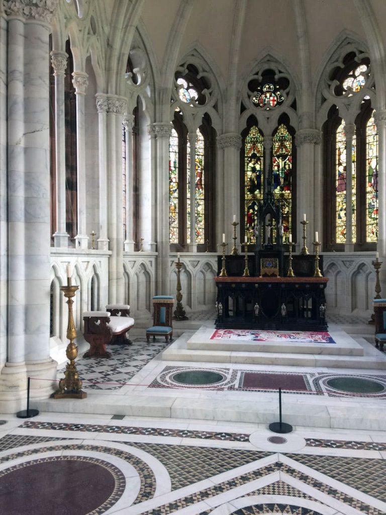 A marble altar with stained glass windows.