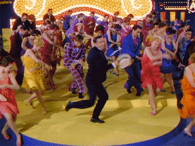 GIF from Singin in the Rain with Gene Kelly dancing with flapper girls.