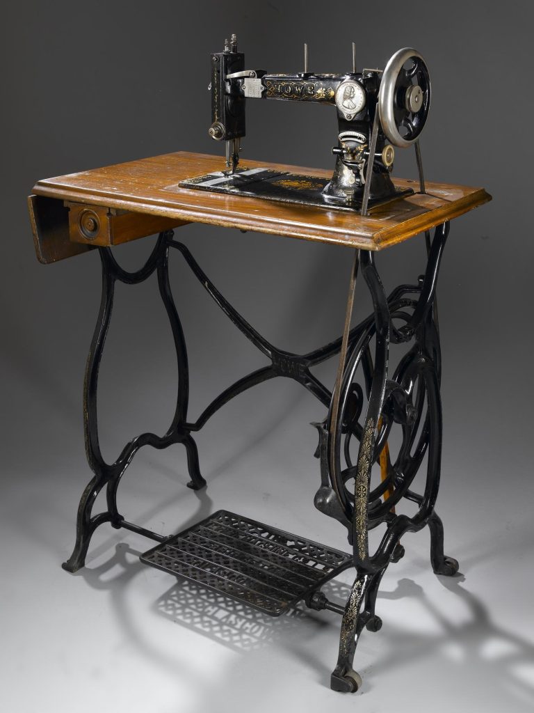 Colour photo of a sewing machine with foot treadle mechanism.