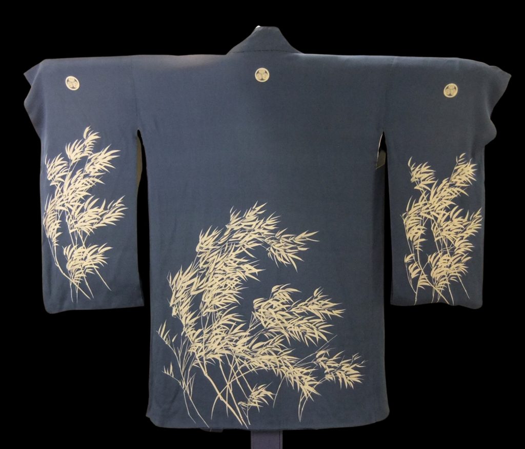 Dusk-blue robe on a hanger decorated with pale yellow bamboo chutes and leaves.