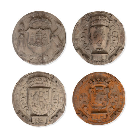 Four oak roundels laid flat facing forward. Three are grey-brown, the fourth almost copper coloured. Each has a coat of arms.