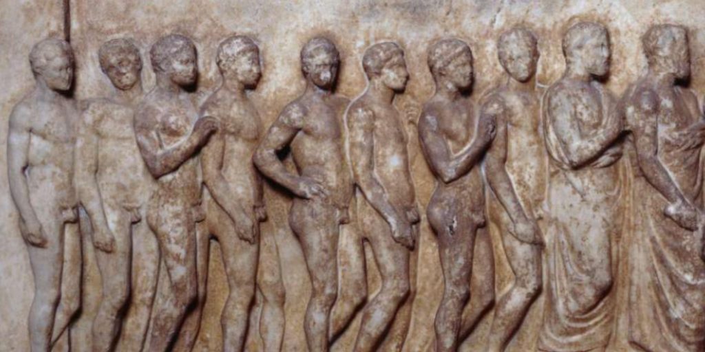 Marble carving of a line of naked athletes standing in profile, all facing right.