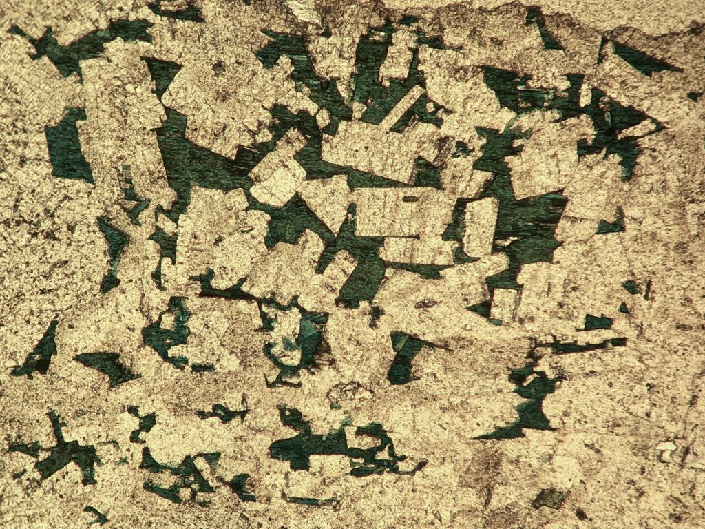 An abstract image of green and gold mineral.