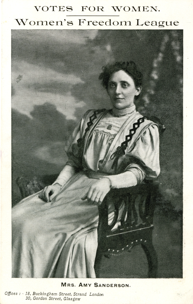 Black and white photo of a woman sitting in a chair.