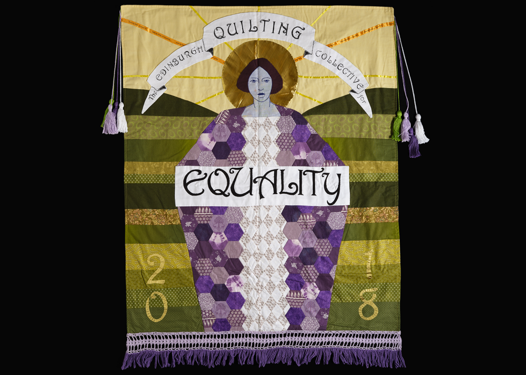 A green and purple quilted banner showing a women with the word "Equality" across her.