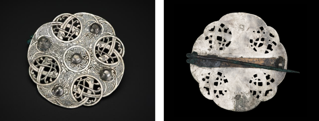 Side-by-side of the front and back of the clean, shining, conserved silver brooch with all details visible. 