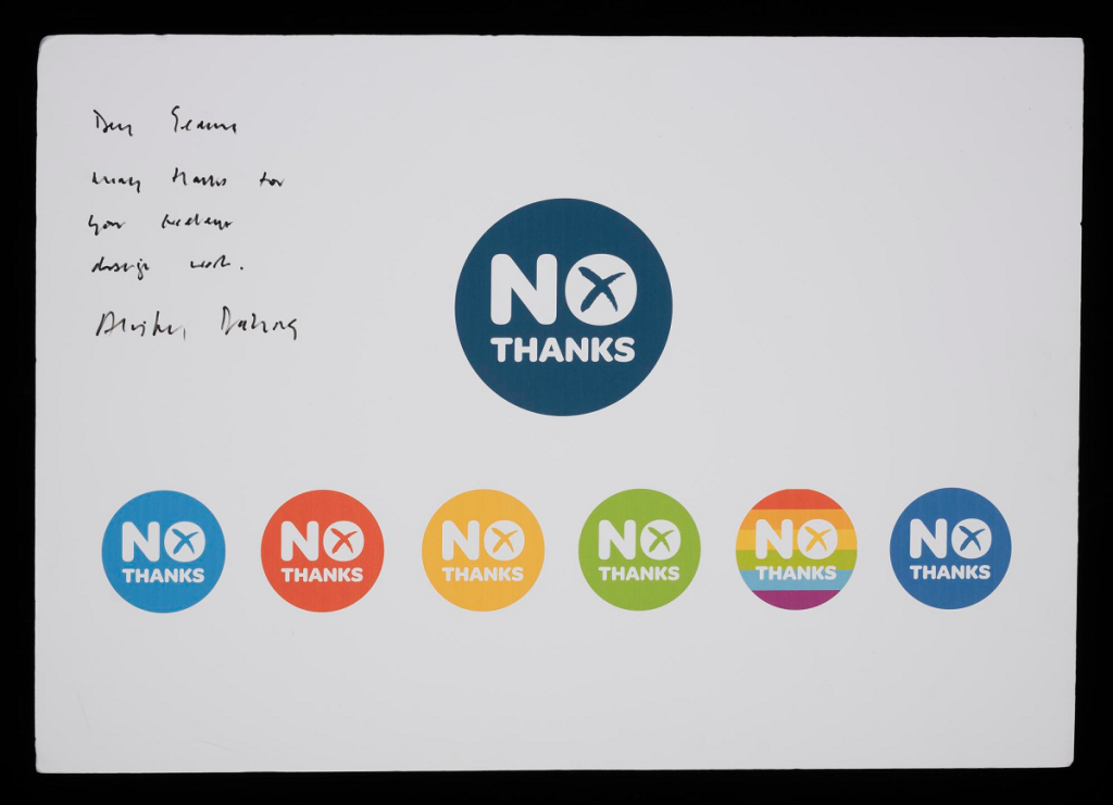 Paper sign with a central blue and white 'No Thanks' logo, six identical logos in various colours below it, and handwritten scribble on the left side.