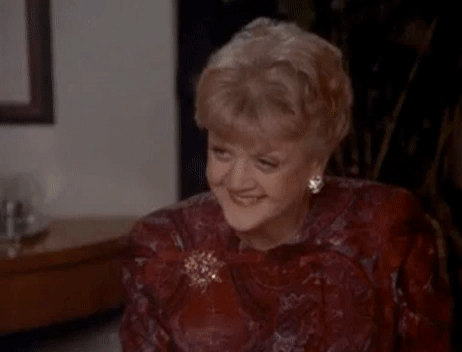 GIF of Jessica Fletcher laughing, wearing a brooch.