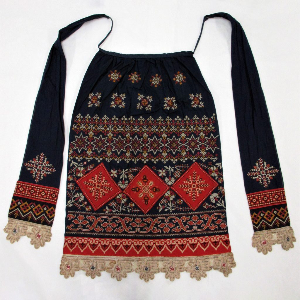 Woman’s apron in dark blue cotton, embroidered with cotton threads in cross stitch.