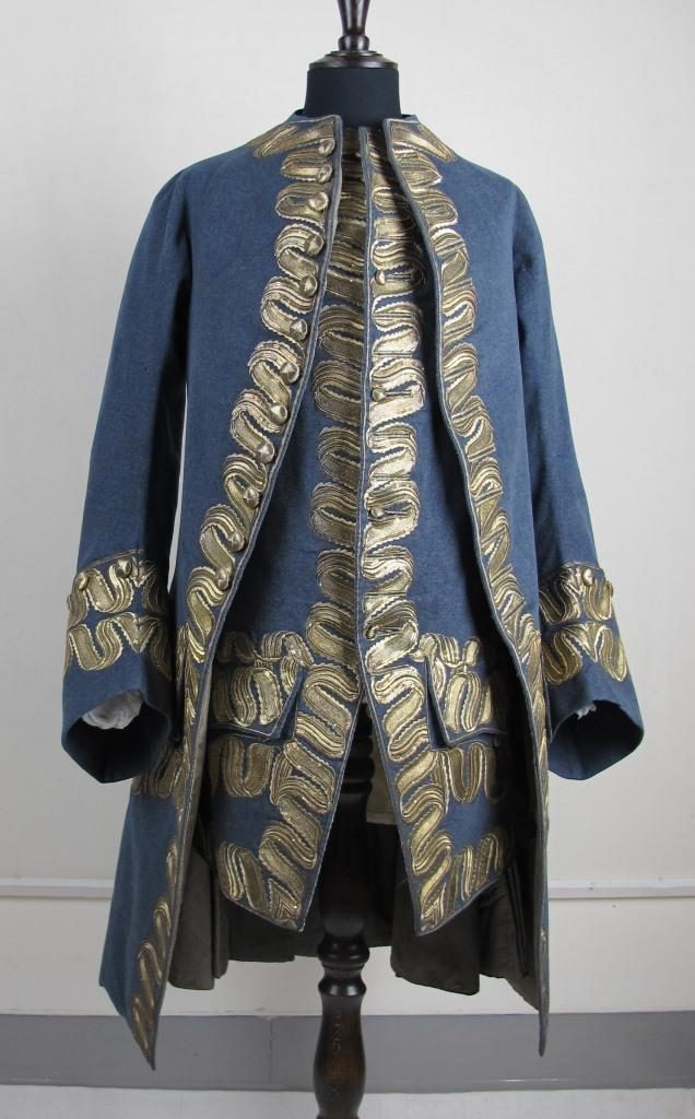 Light navy blue waistcoat with golden embroidery around the central split and sleeves. 