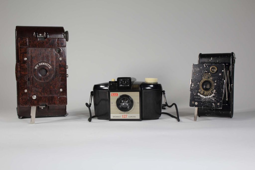Colour photo of three cameras lined up left to right.