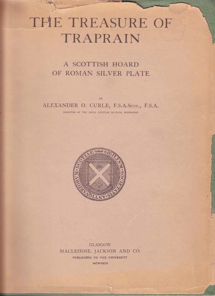 Plain light brown book cover with torn edges. Titled 'The Treasure of Traprain: A Scottish Hoard of Roman Silver Plate'. Logo of the Society of Antiquaries of Scotland is below the title.