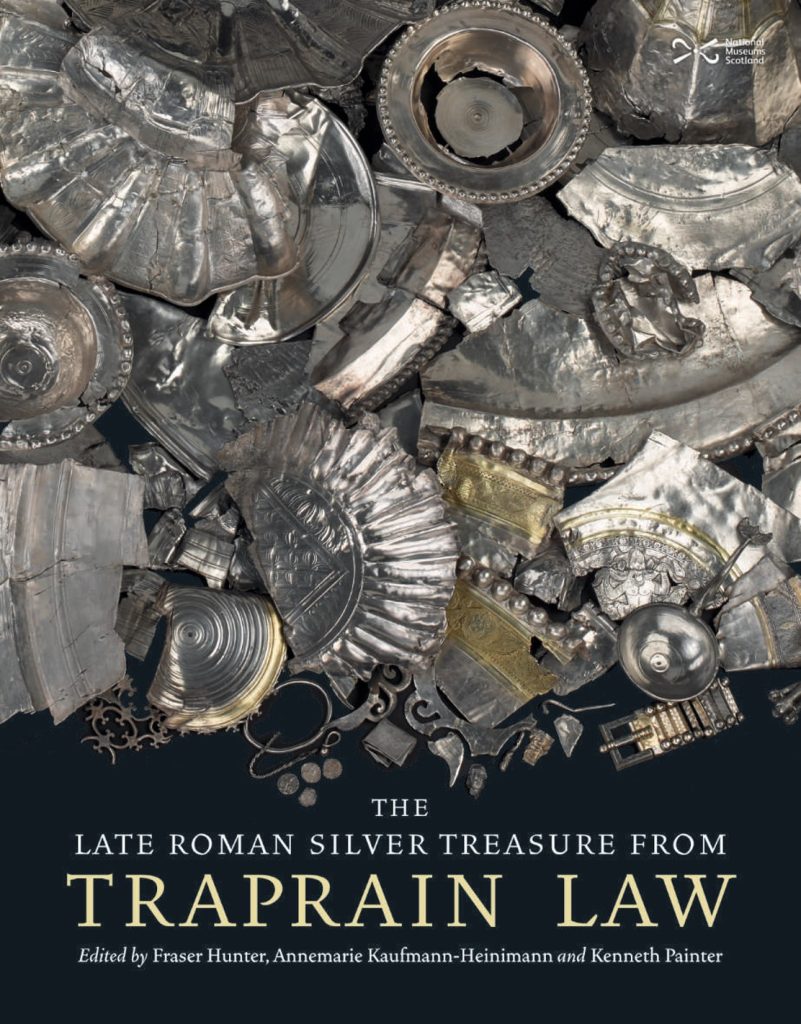 Cover of the book 'The Late Roman Silver Treasure from Traprain Law'. A pile of silver fragments including drinking and eating vessels on a black background.
