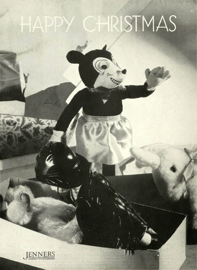 Black and white photo of a early Mickey Mouse toy and with other soft toys in a Christmas advertisement.