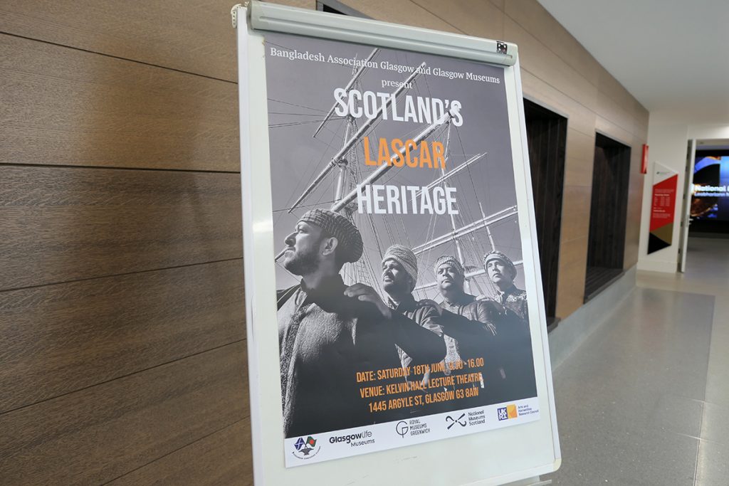 A poster with Brown men standing together in front of a sailing boat with the words "Scotland's Lascar Heritage" on it.