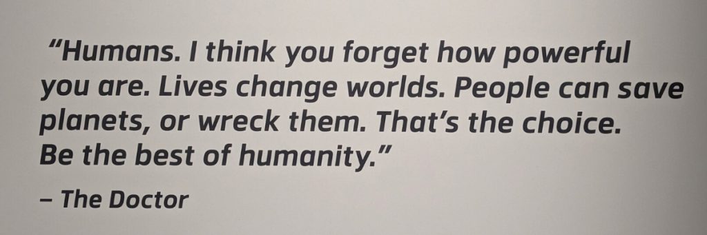 Quote in black, sans-serif font against an off-white background. The quote from The Doctor reads, "Humans. I think you forget how powerful you are. Lives change worlds. People can save planets, or wreck them. That's the choice. Be the best of humanity."