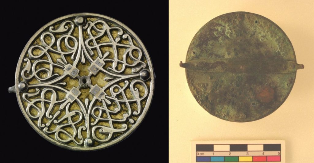 Two images side-by-side showing the front (left) and back (right) of a different circular brooch. This one has a flowing interlace design with gold colouring, and its back is rusted and flat with a simple, broad pin.
