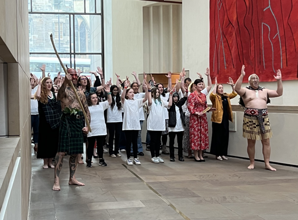 A group of people perform a Māori haka in Hawthornden Court at the National Museum of Scotland.