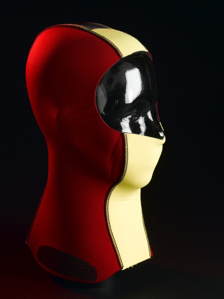 A red and yellow balaclava on a mannequin head. 